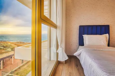 a bedroom with a bed and a view of the ocean at BlueVista - Yacht like Escape with Ocean Views in Rabat