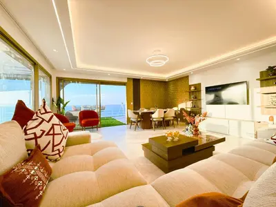 a large living room with a couch and a table at BlueVista - Yacht like Escape with Ocean Views in Rabat
