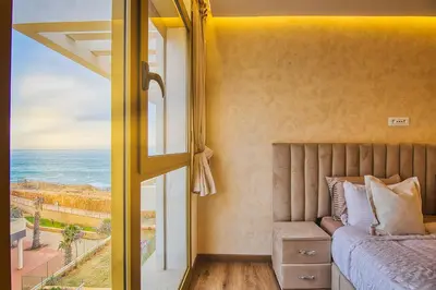 a bedroom with a bed and a view of the ocean at BlueVista - Yacht like Escape with Ocean Views in Rabat