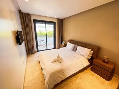 a bedroom with a large bed with a window at Ma Raffiné Ziraoui in Casablanca