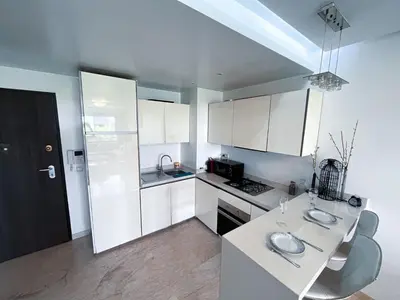 a kitchen with white cabinets and a white counter top at Ma Raffiné Ziraoui in Casablanca