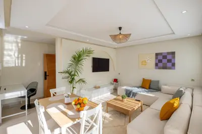 a living room with a couch and a table at Charming Cozy apartments with terrace, Haut Agdal in Rabat
