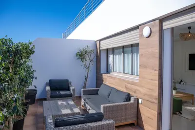 a patio with a couch and chairs on a balcony at Charming Cozy apartments with terrace, Haut Agdal in Rabat