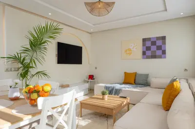 a living room with a white couch and a table at Charming Cozy apartments with terrace, Haut Agdal in Rabat