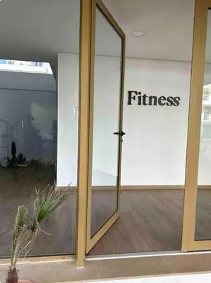 a glass door with the word fitness written on it at La perle du carrousel in Rabat