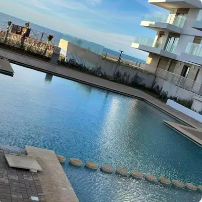 a large swimming pool in front of a building at La perle du carrousel in Rabat