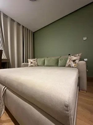 a bedroom with a bed and a green wall at Spacious Apartment 3BR by CH Hay riad, Rabat in Rabat