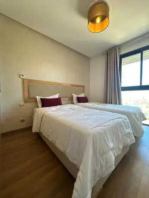 a bedroom with a large bed with white sheets at Spacious Apartment 3BR by CH Hay riad, Rabat in Rabat