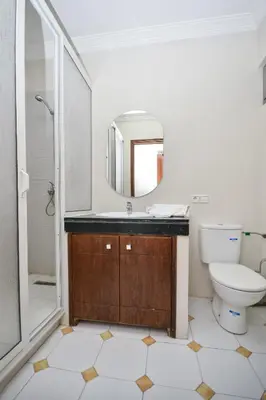 a bathroom with a sink and a toilet and a mirror at Cozy 2 BR Gauthier Oasis in Casablanca