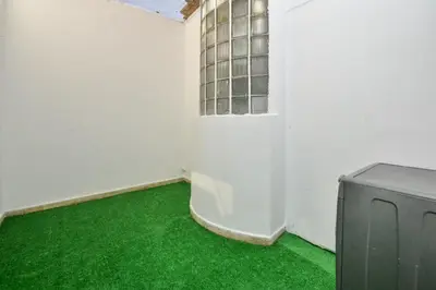 a room with a green floor and a window at Cozy 2 BR Gauthier Oasis in Casablanca