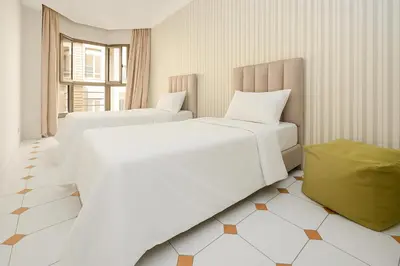 two beds in a hotel room with at Cozy 2 BR Gauthier Oasis in Casablanca