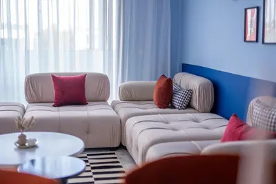 a living room with two couches with pillows on them at The lodge Residence by Goodmove - Hay Riad in Rabat