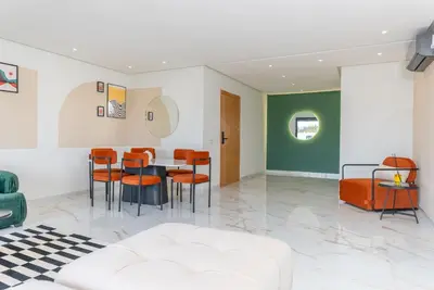 a living room with a table and chairs at The lodge Residence by Goodmove - Hay Riad in Rabat
