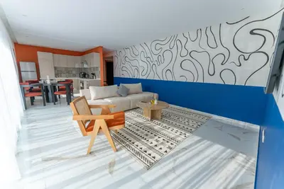 a living room with a couch and a table at The lodge Residence by Goodmove - Hay Riad in Rabat