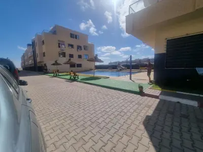 a courtyard with a pool and a building at الشروق in Pont Blondin