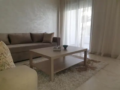 a living room with a couch and a coffee table at La perle in Pont Blondin