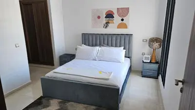 a bedroom with a bed with white sheets and pillows at Voyager in Souk el Had