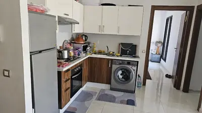 a kitchen with a washer and a washing machine in it at Voyager in Souk el Had