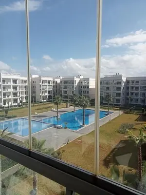 a view of a swimming pool from a window at Voyager in Souk el Had