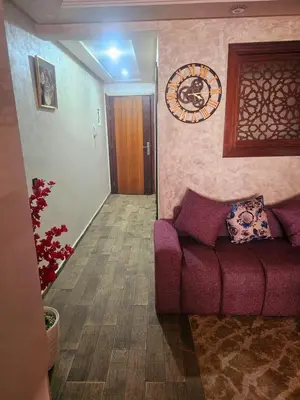 a living room with a purple couch and a hallway at Mi mini estudio 3 in Rabat