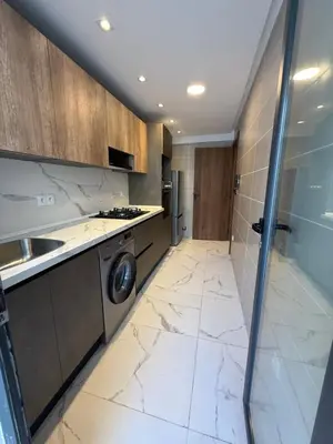a large kitchen with marble flooring and a washer at NEW apartment heart of Rabat city center in Rabat