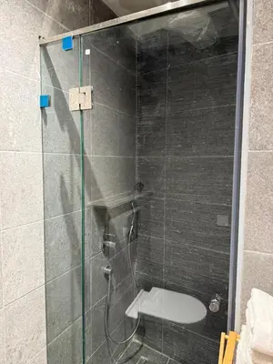 a glass shower with a toilet in a bathroom at NEW apartment heart of Rabat city center in Rabat