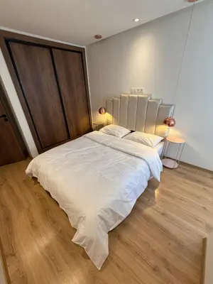 a large white bed in a room with wooden floors at NEW apartment heart of Rabat city center in Rabat