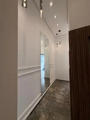 a hallway with white walls and a glass wall at NEW apartment heart of Rabat city center in Rabat