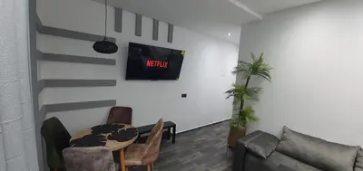 a living room with a table and a couch at Cozy Apartement B-House Airport in Berrechid