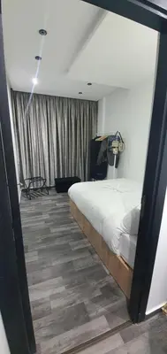a bedroom with a large bed in a room at Cozy Apartement B-House Airport in Berrechid