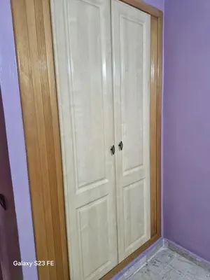 a closet with white doors in a room at Baghdad 4 in Aïn Harrouda
