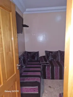 a room with two couches sitting next to a door at Baghdad 4 in Aïn Harrouda
