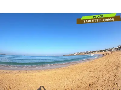 a shadow of a person standing on a beach at Bel Appartement à louer à Mansouria in Pont Blondin