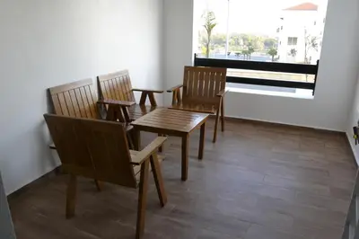 a dining room with chairs and a table and a window at Bel Appartement à louer à Mansouria in Pont Blondin