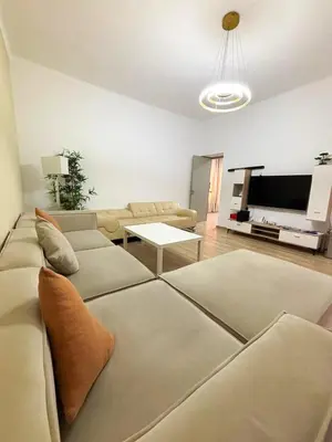 a living room with a couch and a tv at Spacious Apartment Entire Villa Floor 2 Bedrooms in Rabat