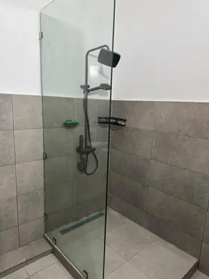 a shower with a glass door in a bathroom at Spacious Apartment Entire Villa Floor 2 Bedrooms in Rabat
