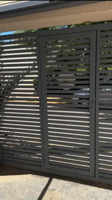 a garage door with metal gates on a building at Spacious Apartment Entire Villa Floor 2 Bedrooms in Rabat