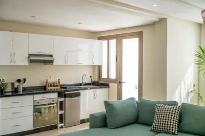 a living room with a blue couch in a kitchen at Very Charming Apartments with balcony, Haut Agdal in Rabat