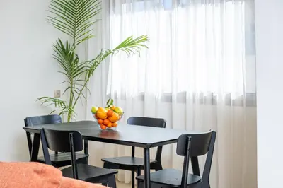 a dining room table with a bowl of fruit on it at Very Charming Apartments with balcony, Haut Agdal in Rabat