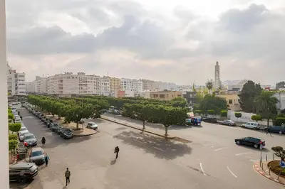 a city street with cars parked in a parking lot at Luxury Central 3BR 5min from Beach & Shopping in Casablanca