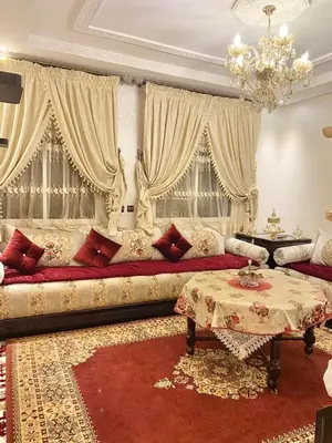 a living room with a couch and a table at Luxurious Holiday Home2 in Temara