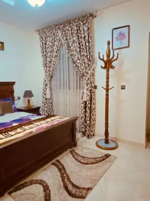 a bedroom with a bed and a large window at Luxurious Holiday Home2 in Temara