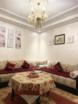 a living room with a couch and a table at Luxurious Holiday Home2 in Temara