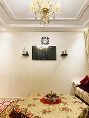 a living room with a table and a chandelier at Luxurious Holiday Home2 in Temara