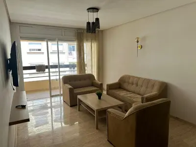 a living room with two couches and a table at Appartement haut standing Mohammedia Parc in Mohammedia