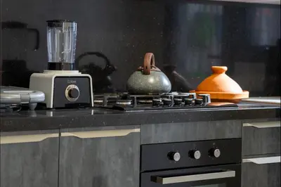 a kitchen stove with a blender on top of it at Appart Moderne Tamaris Piscine, Plage et Confort in Tamaris