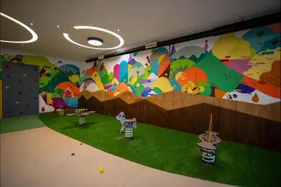 a room with a colorful mural on the wall at Appart Moderne Tamaris Piscine, Plage et Confort in Tamaris