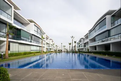 a swimming pool in the middle of a building at Appart Moderne Tamaris Piscine, Plage et Confort in Tamaris