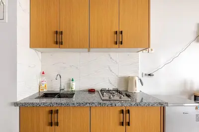 a kitchen with wooden cabinets and a counter top at Cozy studio moderne Agdal in Rabat
