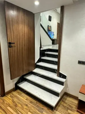 a staircase in a room with a door and a stair case at Emma's Duplex in Casablanca